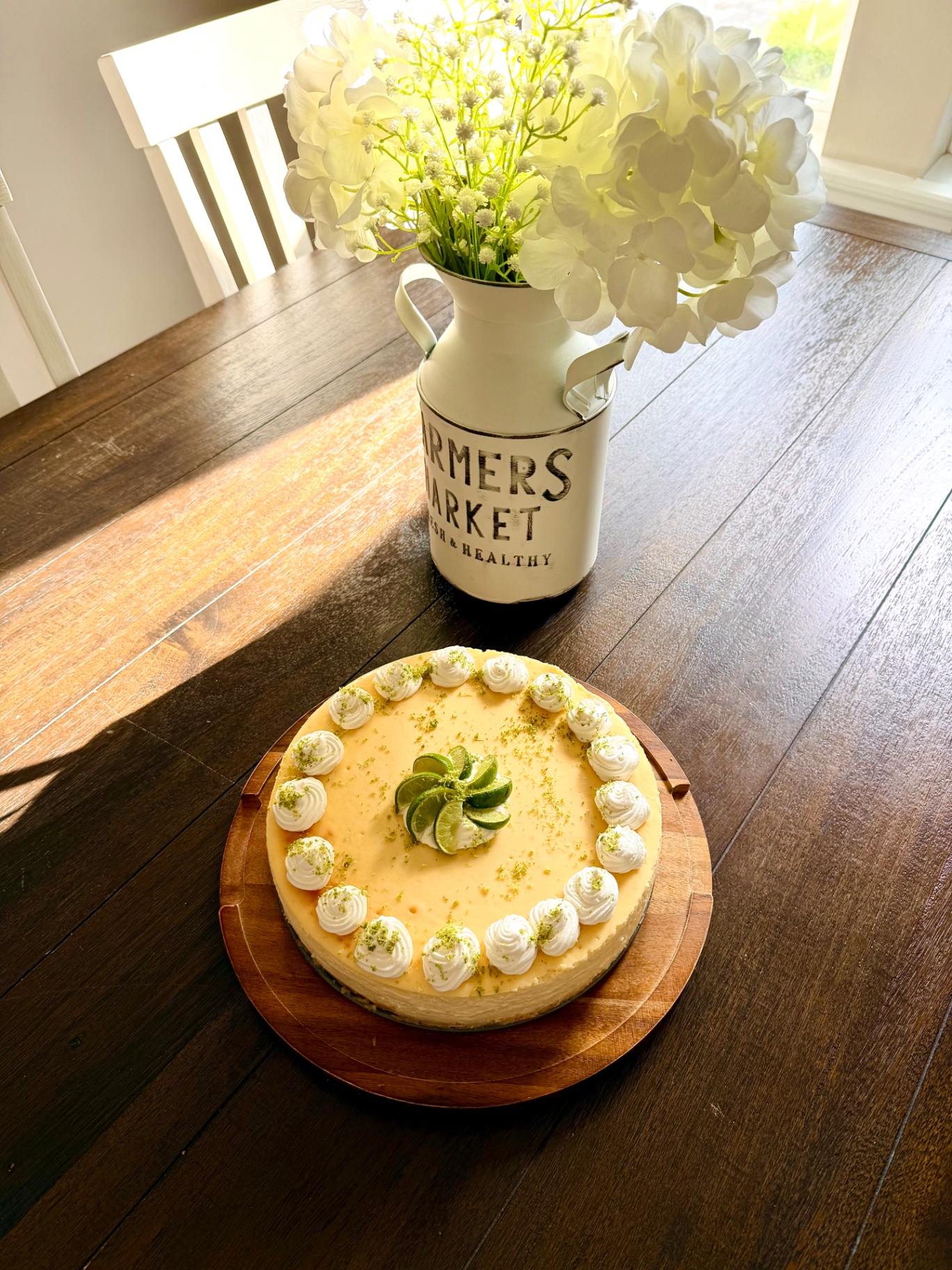 Key Lime Cheesecake on a wooden board with farmhouse styling